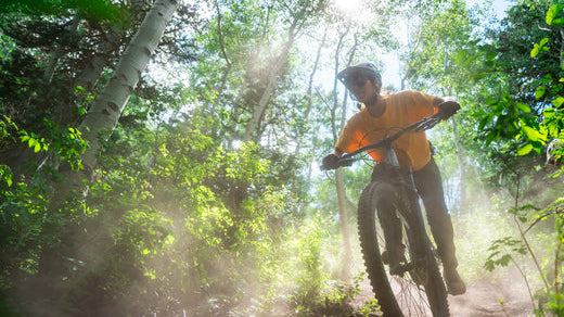 Biker riding downhill on a mountain bike rental from Skis on the Run