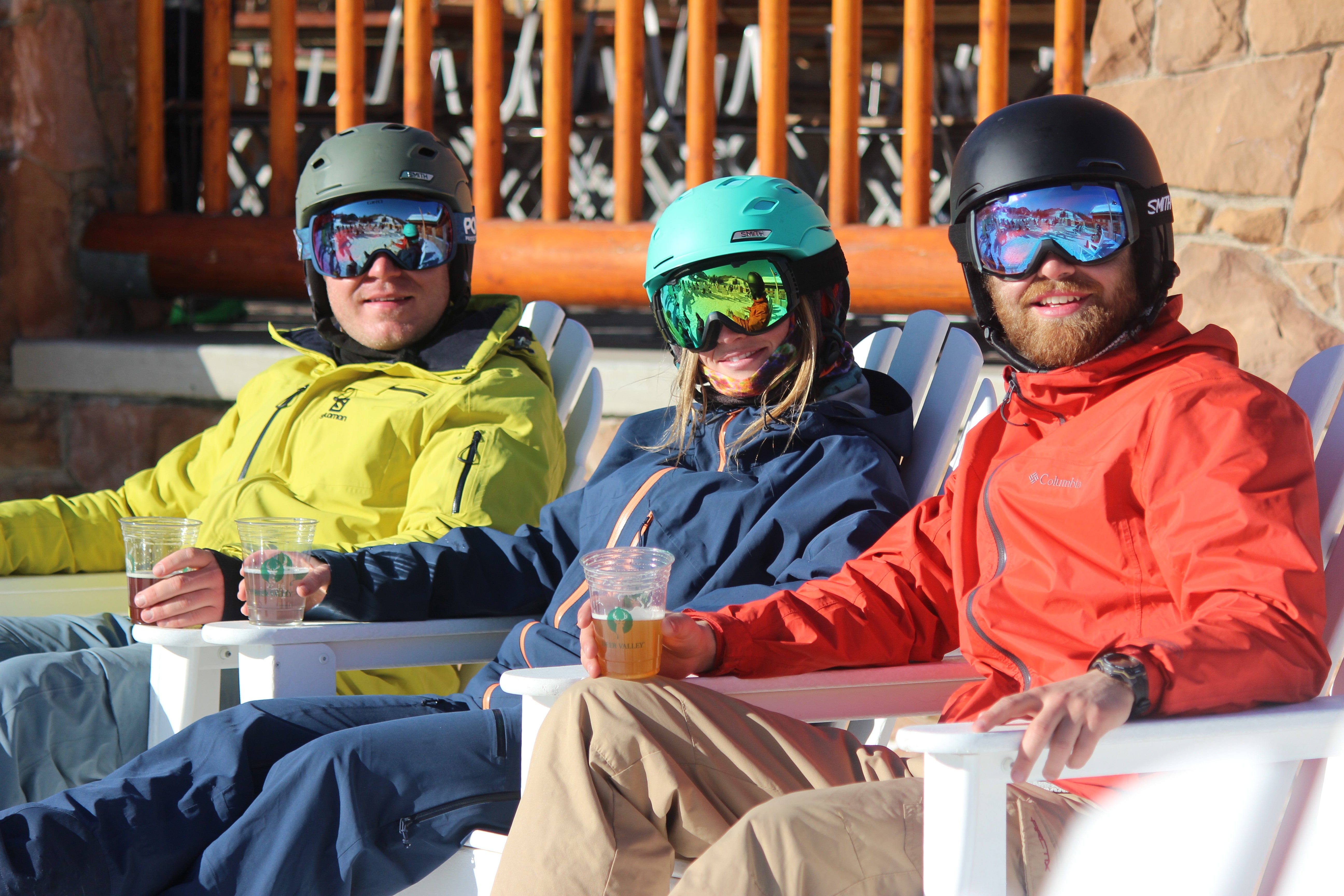 Three people enjoying their ski rentals for their corporate retreat