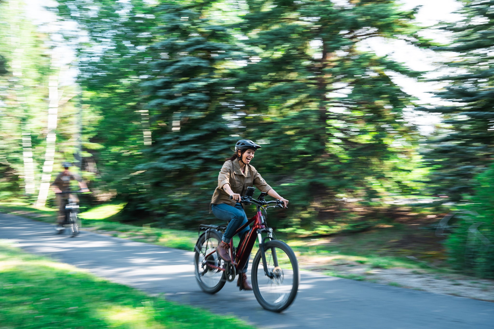Two people riding on electric city bike rentals from Skis on the Run in Park City, Utah.