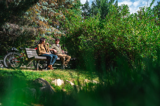 Two people sitting on a bench with their mountain bike rental in Park City, Utah