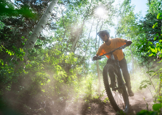 Biker riding downhill on a mountain bike rental from Skis on the Run