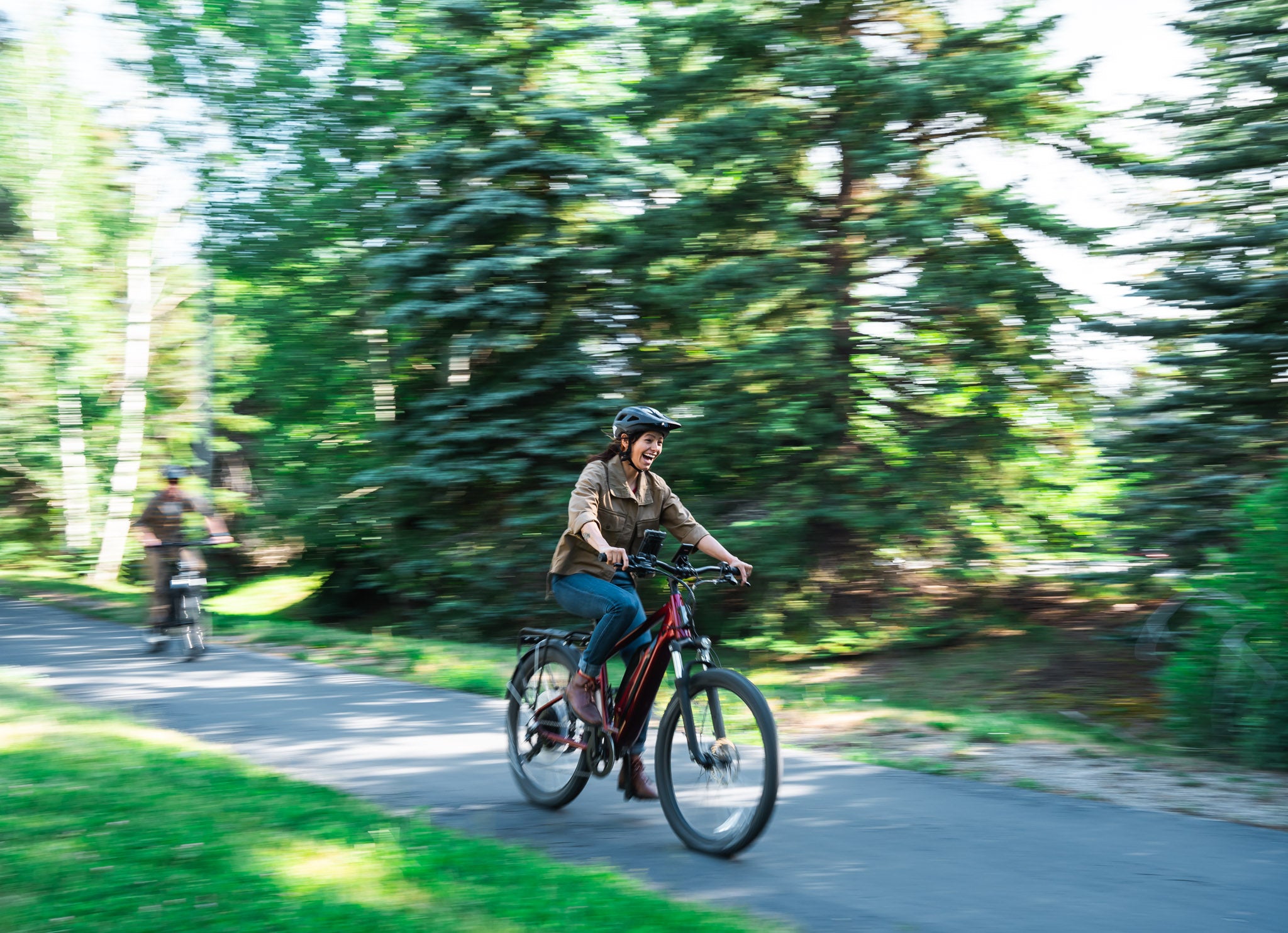 Two people riding on electric city bike rentals from Skis on the Run in Park City, Utah.