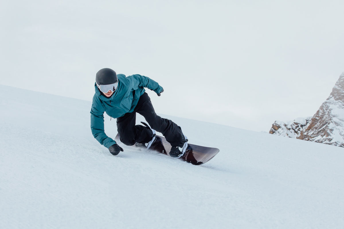 Snowboarder riding on a Skis on the Run snowboard rental in Park City Mountain Resort